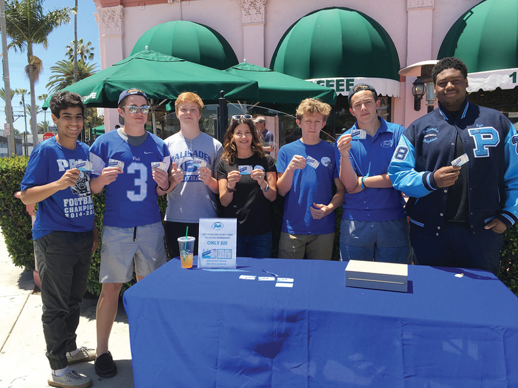 Football mom Lisa Taitelman (center) joined Palisades High School football team members (left to right) Kian Farahdel, Jared Dodson, Jack Estabrook, Theo Shulsky, Jonah Manheim and Syr Riley to sell discount cards to raise money for the football program.