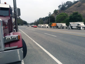 Trucks are lined up on both sides of Temescal Canyon Road early morning.