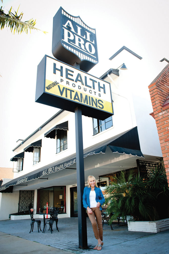 Diane Berk, owner of All-Pro Health and Nutrition, in front of the store on Via de la Paz. Photo: Lesly Hall
