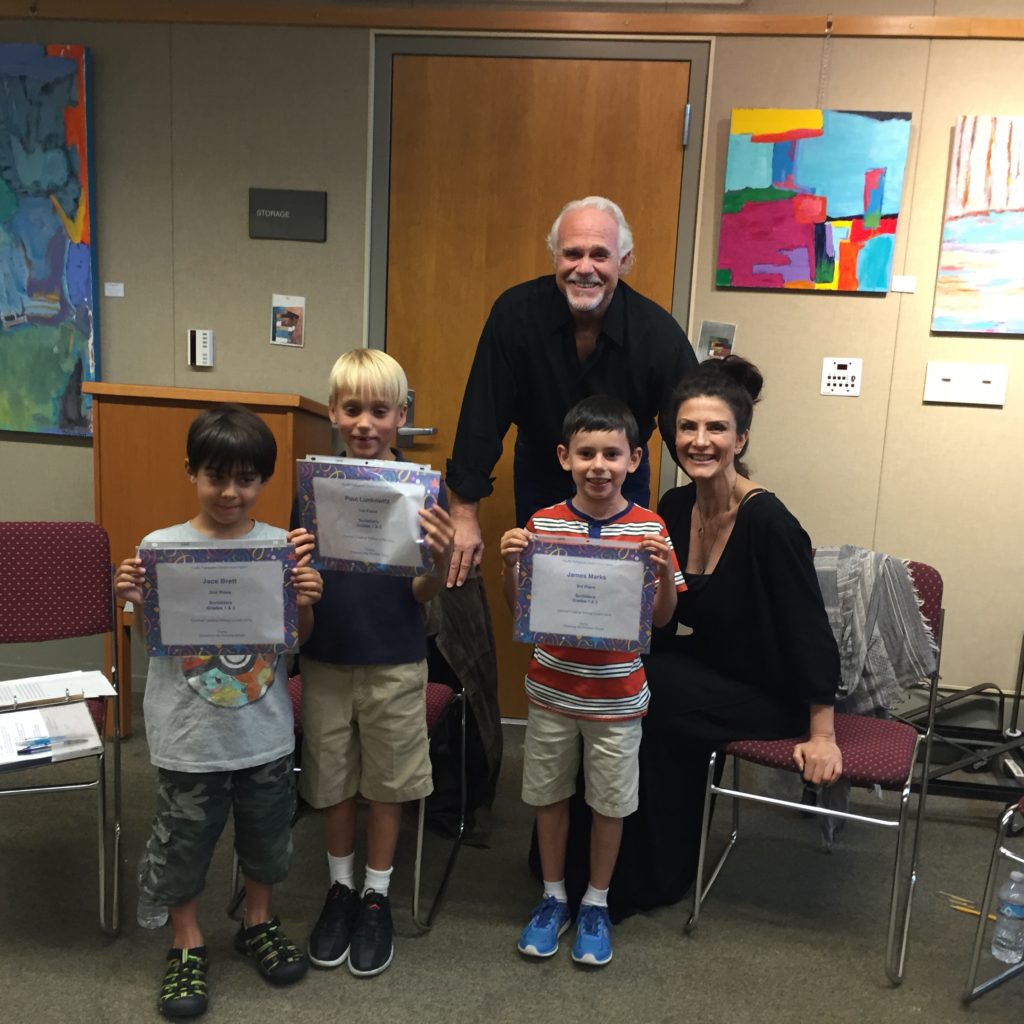 Photo: (Left to right) Jace Brett (second), Paul Lunkewitz (first) and James Marks (third) in the first and second grade category posed with actors Bill Jones and Christine Kjudjian.